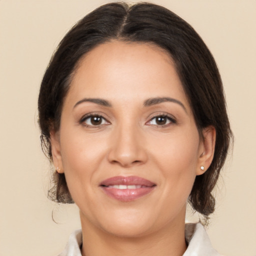 Joyful white adult female with medium  brown hair and brown eyes