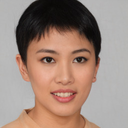 Joyful asian young-adult female with short  brown hair and brown eyes