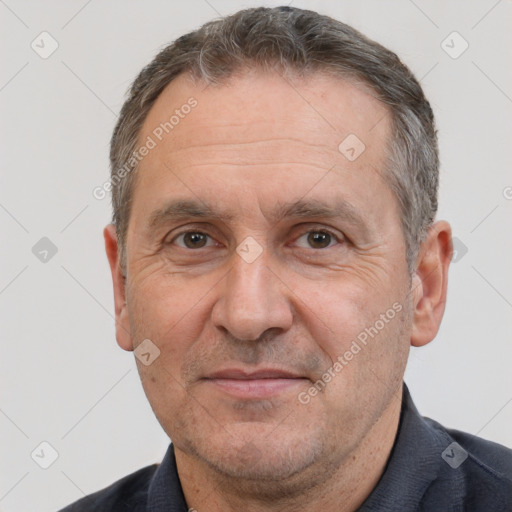 Joyful white middle-aged male with short  brown hair and brown eyes