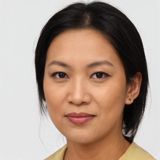 Joyful asian young-adult female with medium  black hair and brown eyes