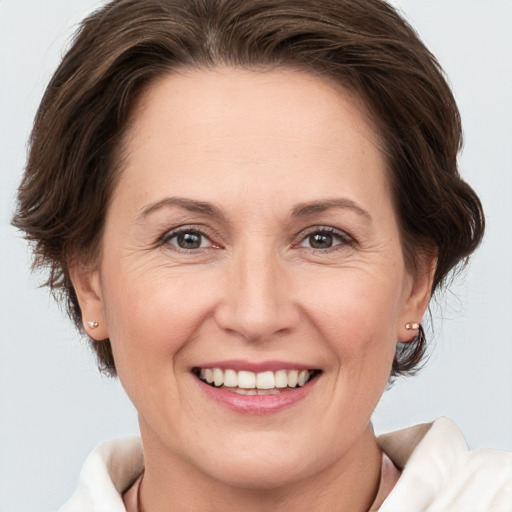 Joyful white adult female with medium  brown hair and brown eyes