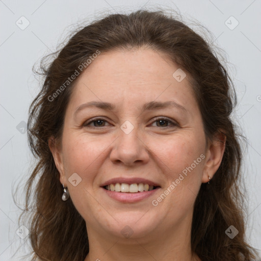 Joyful white adult female with long  brown hair and grey eyes