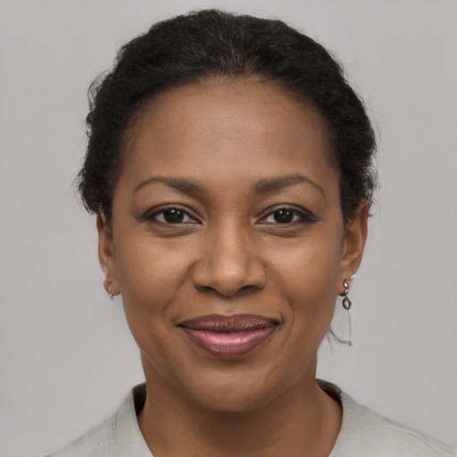 Joyful black young-adult female with short  brown hair and brown eyes
