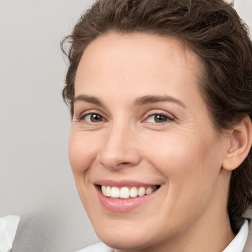 Joyful white young-adult female with medium  brown hair and green eyes