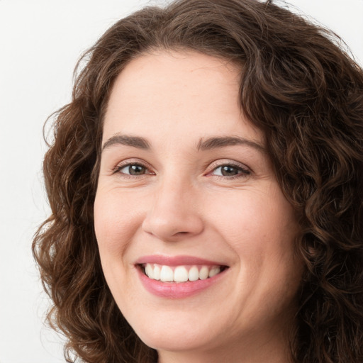 Joyful white young-adult female with long  brown hair and green eyes