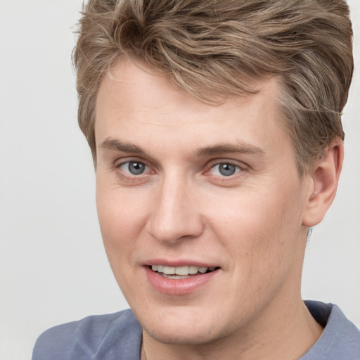 Joyful white adult male with short  brown hair and grey eyes