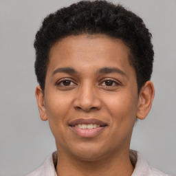 Joyful latino young-adult male with short  brown hair and brown eyes