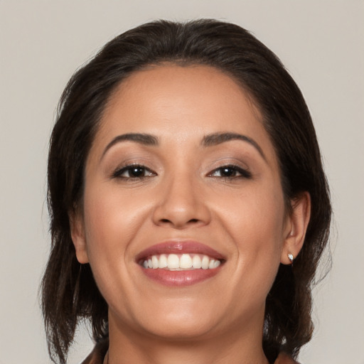 Joyful white young-adult female with medium  brown hair and brown eyes