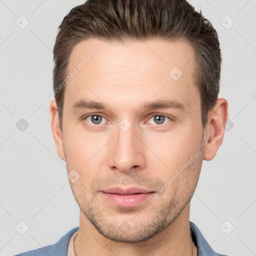 Joyful white young-adult male with short  brown hair and brown eyes