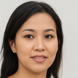 Joyful asian young-adult female with long  brown hair and brown eyes