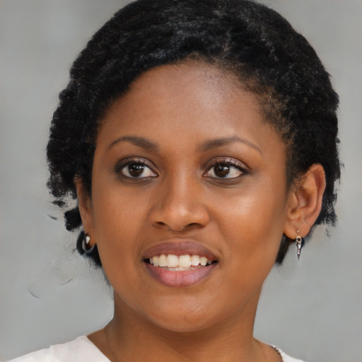 Joyful black young-adult female with medium  black hair and brown eyes