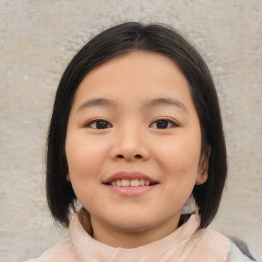 Joyful asian child female with medium  brown hair and brown eyes