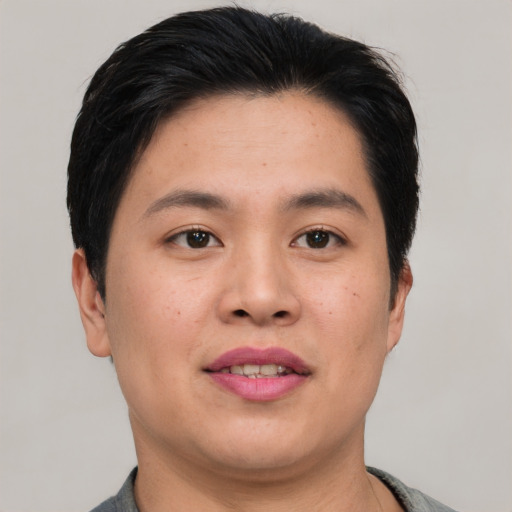 Joyful asian young-adult male with short  black hair and brown eyes