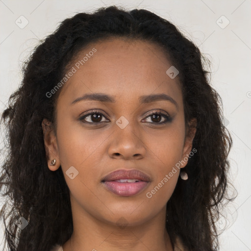 Joyful black young-adult female with long  brown hair and brown eyes