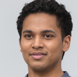 Joyful latino young-adult male with short  brown hair and brown eyes