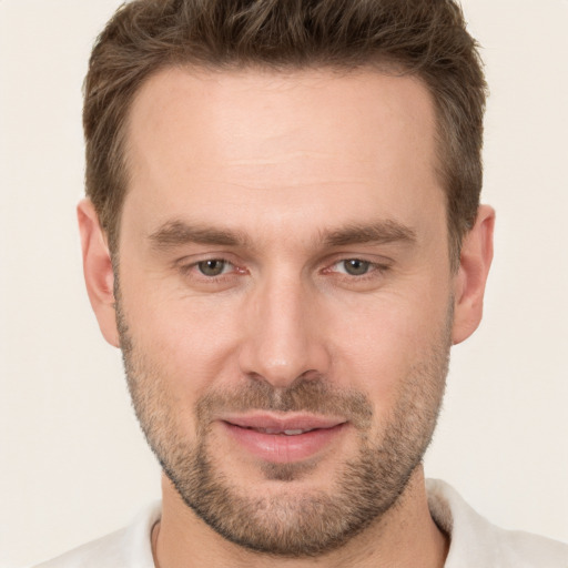 Joyful white young-adult male with short  brown hair and brown eyes