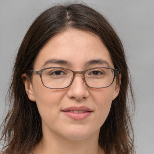 Joyful white adult female with medium  brown hair and brown eyes