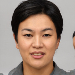 Joyful asian young-adult female with short  black hair and brown eyes