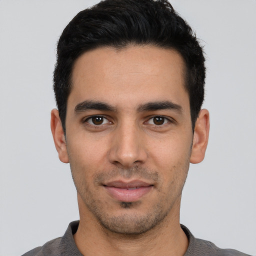 Joyful white young-adult male with short  black hair and brown eyes