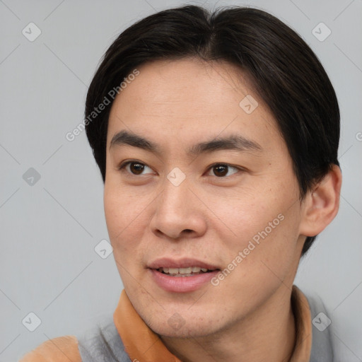 Joyful asian adult male with short  brown hair and brown eyes