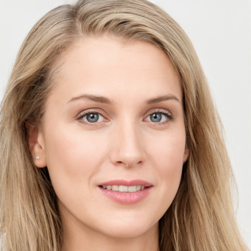 Joyful white young-adult female with long  brown hair and blue eyes