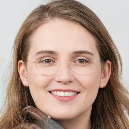 Joyful white young-adult female with long  brown hair and blue eyes