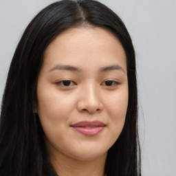 Joyful asian young-adult female with long  brown hair and brown eyes