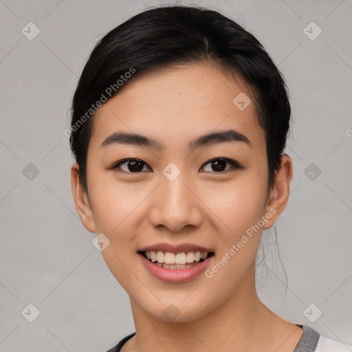 Joyful asian young-adult female with short  black hair and brown eyes