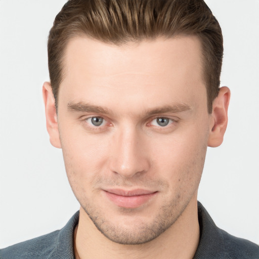 Joyful white young-adult male with short  brown hair and grey eyes