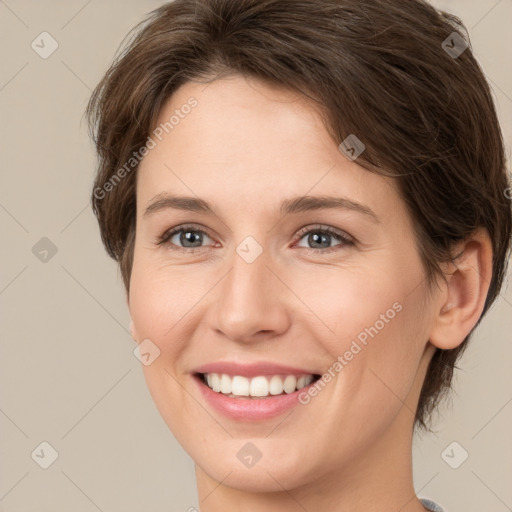 Joyful white young-adult female with medium  brown hair and green eyes