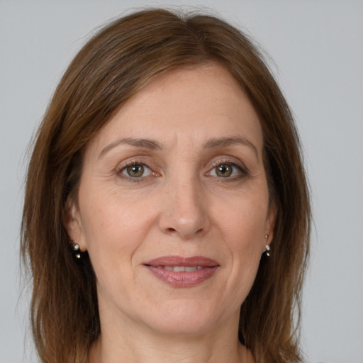 Joyful white adult female with medium  brown hair and brown eyes