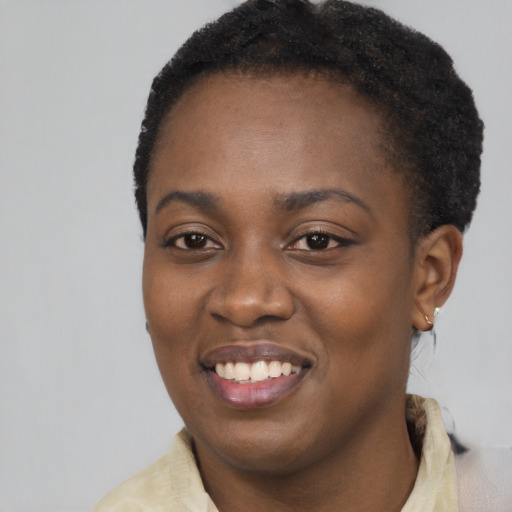 Joyful latino young-adult female with short  black hair and brown eyes