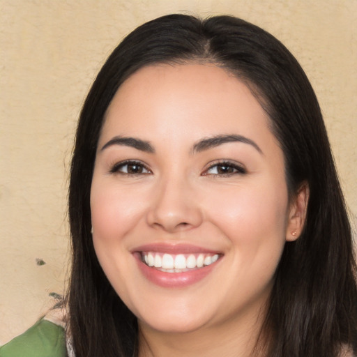 Joyful white young-adult female with long  black hair and brown eyes