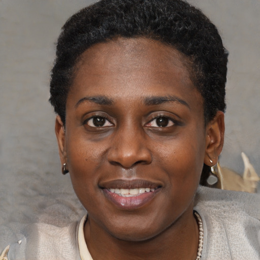 Joyful black young-adult female with short  brown hair and brown eyes