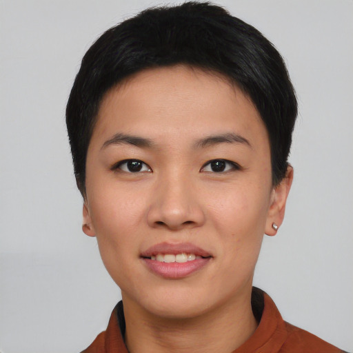 Joyful asian young-adult female with short  black hair and brown eyes