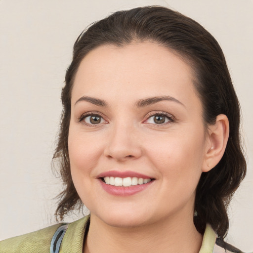 Joyful white young-adult female with medium  brown hair and brown eyes