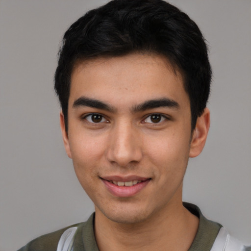 Joyful white young-adult male with short  black hair and brown eyes