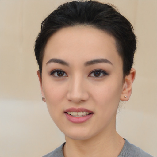 Joyful asian young-adult female with short  black hair and brown eyes