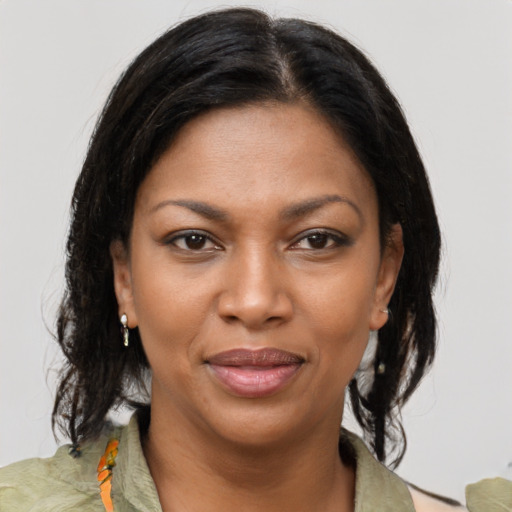 Joyful black young-adult female with medium  brown hair and brown eyes