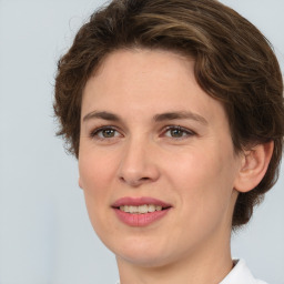 Joyful white young-adult female with medium  brown hair and green eyes