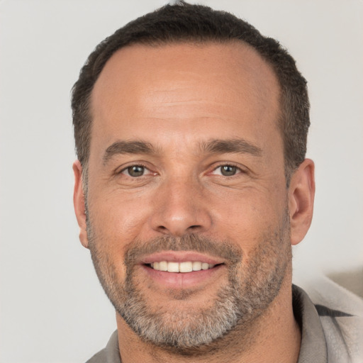 Joyful white adult male with short  brown hair and brown eyes