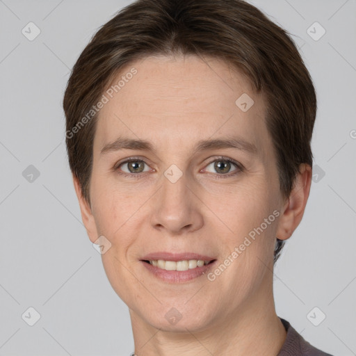 Joyful white adult female with short  brown hair and grey eyes