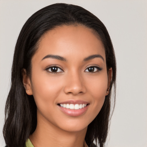 Joyful latino young-adult female with long  brown hair and brown eyes