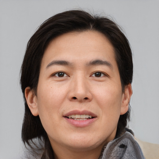 Joyful asian young-adult female with medium  brown hair and brown eyes