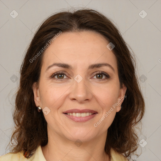 Joyful white adult female with medium  brown hair and brown eyes