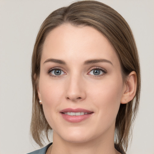 Joyful white young-adult female with medium  brown hair and grey eyes