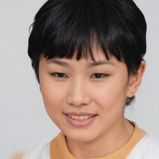 Joyful asian young-adult female with short  black hair and brown eyes