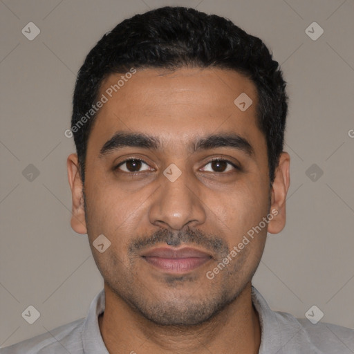 Joyful latino young-adult male with short  black hair and brown eyes