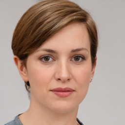 Joyful white young-adult female with medium  brown hair and grey eyes