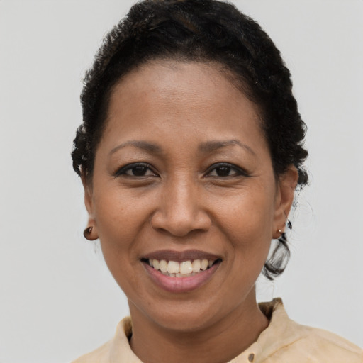 Joyful latino adult female with short  black hair and brown eyes